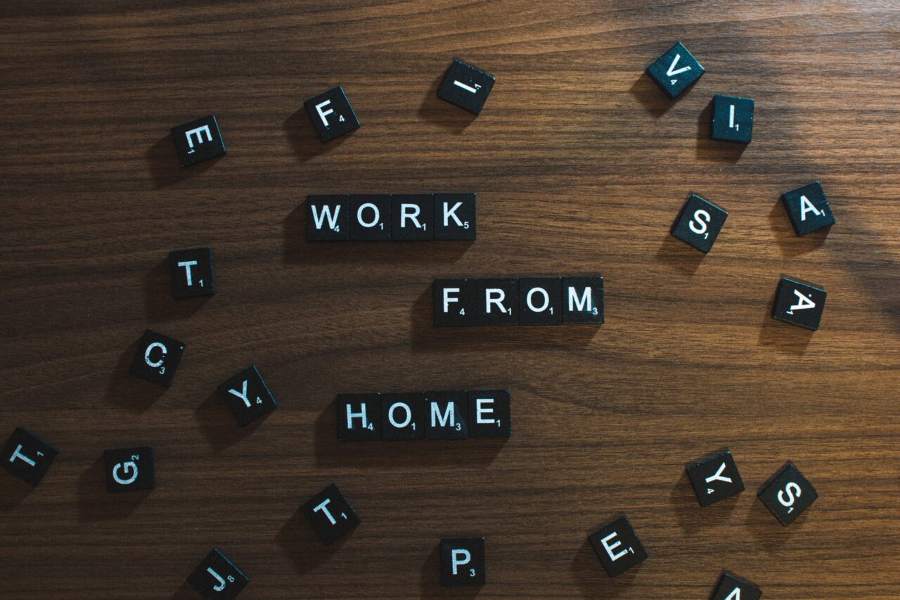 Scrabble pieces forming work from home on a desk